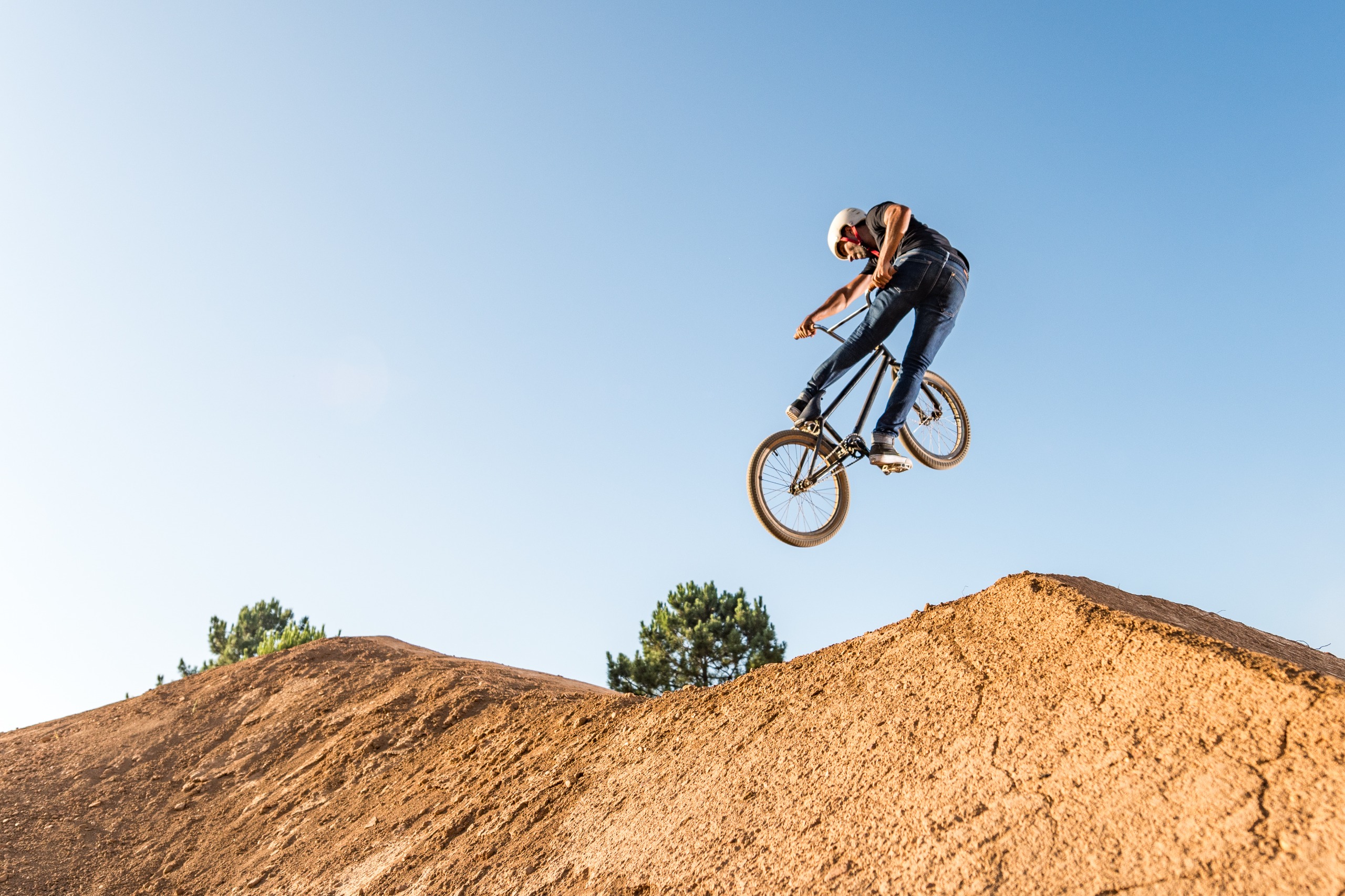 Photo of rider air born over dirt jump